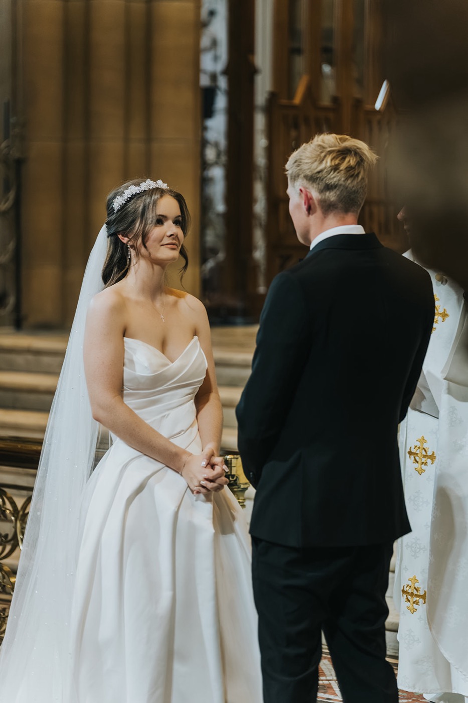 Bride and groom facing each other at the altar