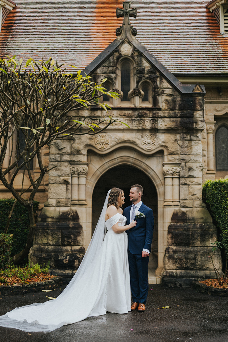 Couple at the arched door of a sandstone chapel
