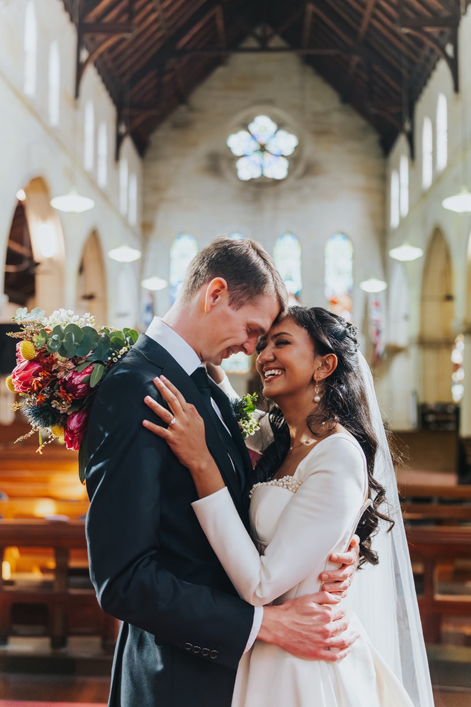 Newlyweds embracing in the church after the ceremony