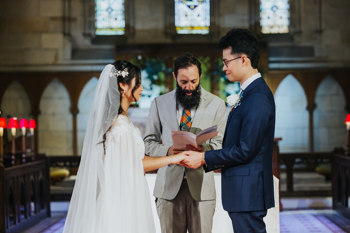 Couple exchanging rings before the minister