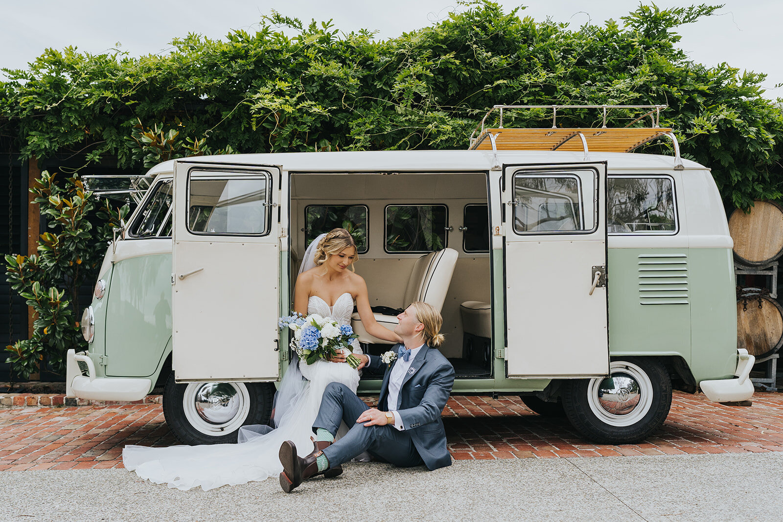 Couple laughing beside a vintage Kombi