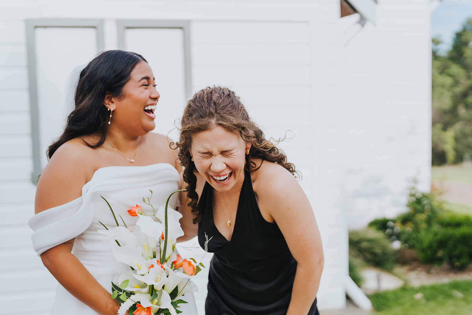 Sophia and a bridesmaid laughing outside the chapel
