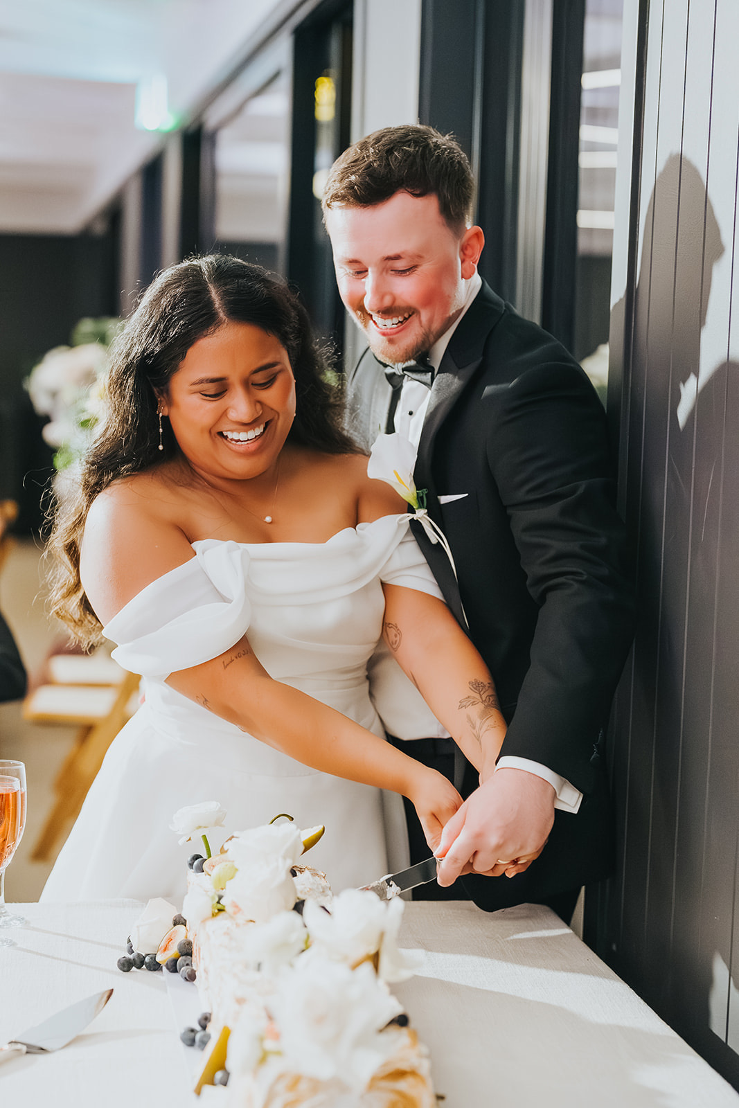 Sophia and Lachlan laughing as they cut the cake