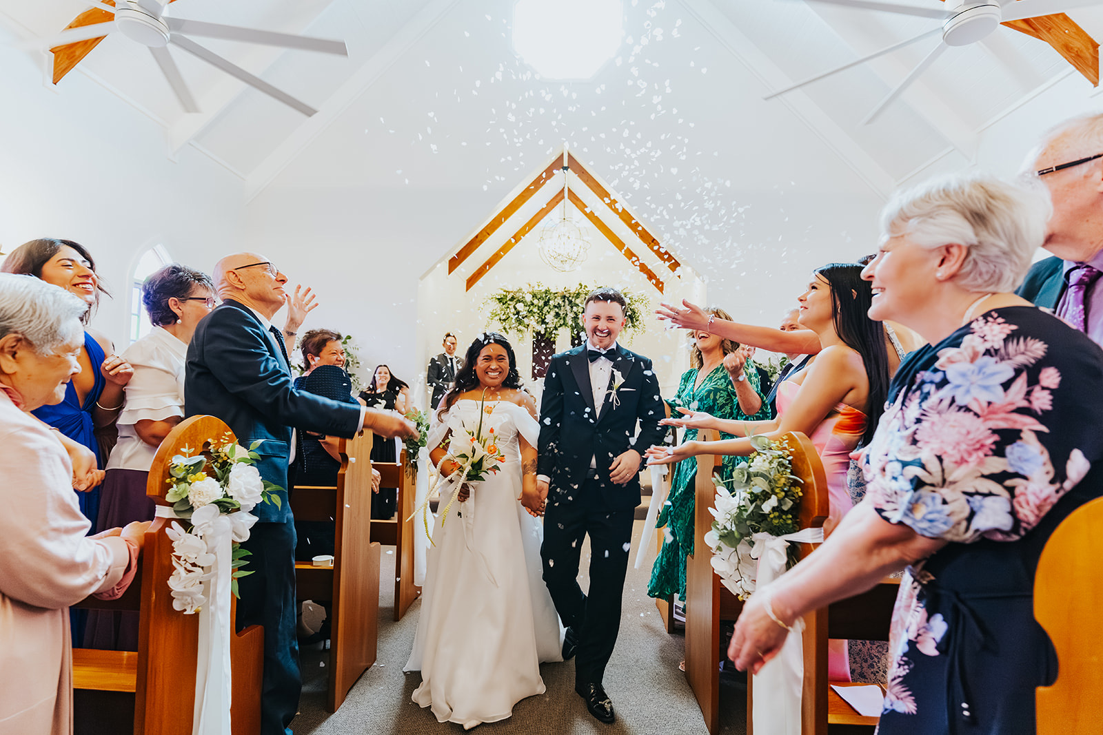 Sophia walking down the aisle of the chapel past her guests