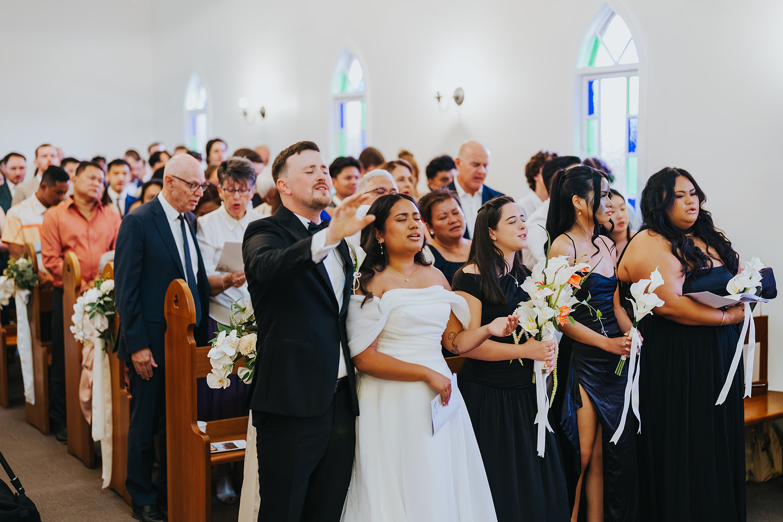 Sophia, Lachlan and their guests singing together in the chapel