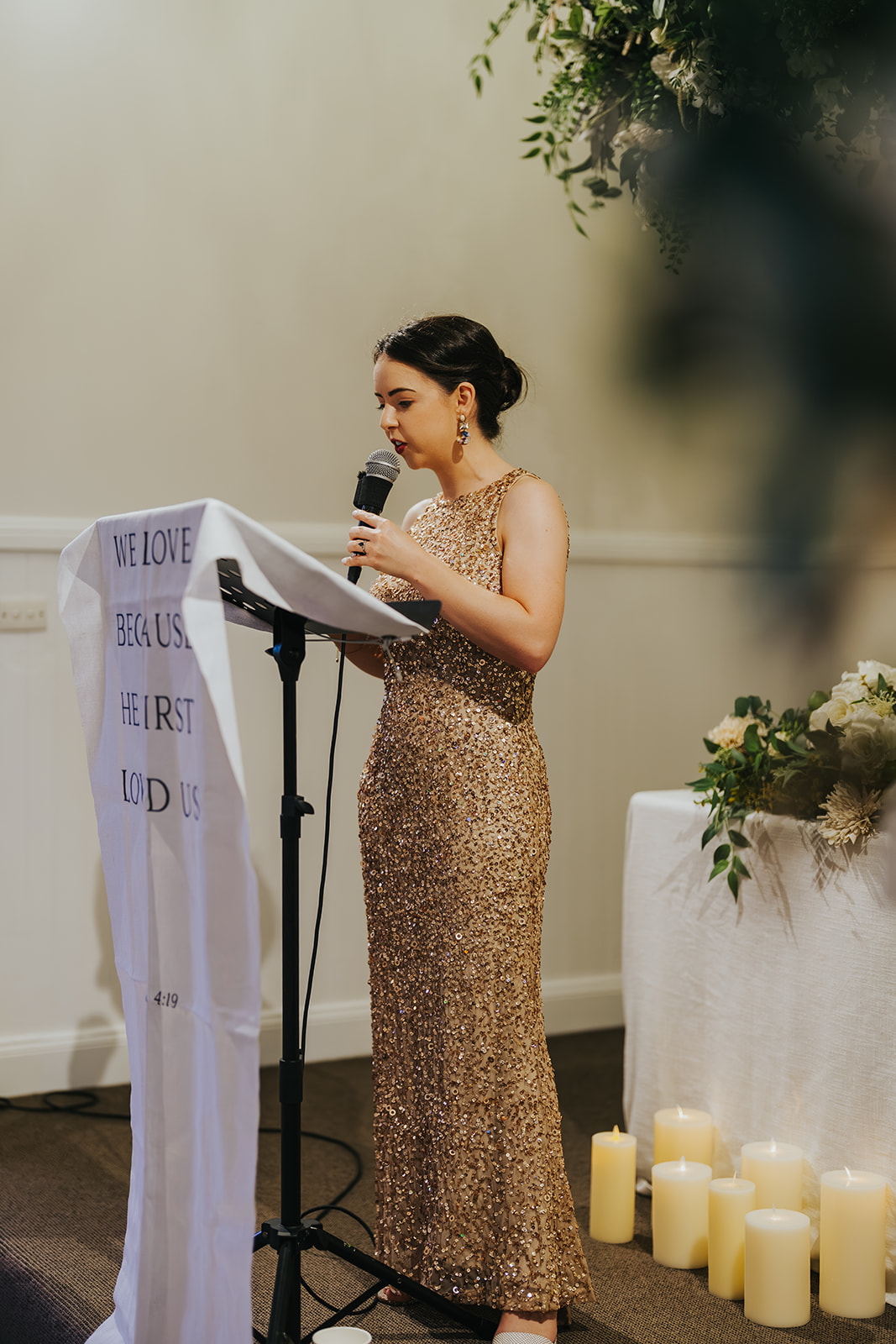 A guest giving a reading at the lectern during the ceremony