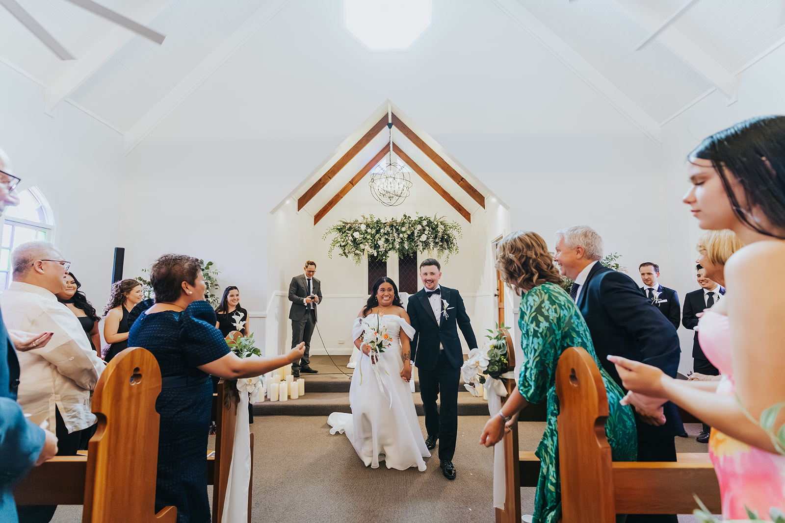Sophia and Lachlan walking back down the aisle as husband and wife