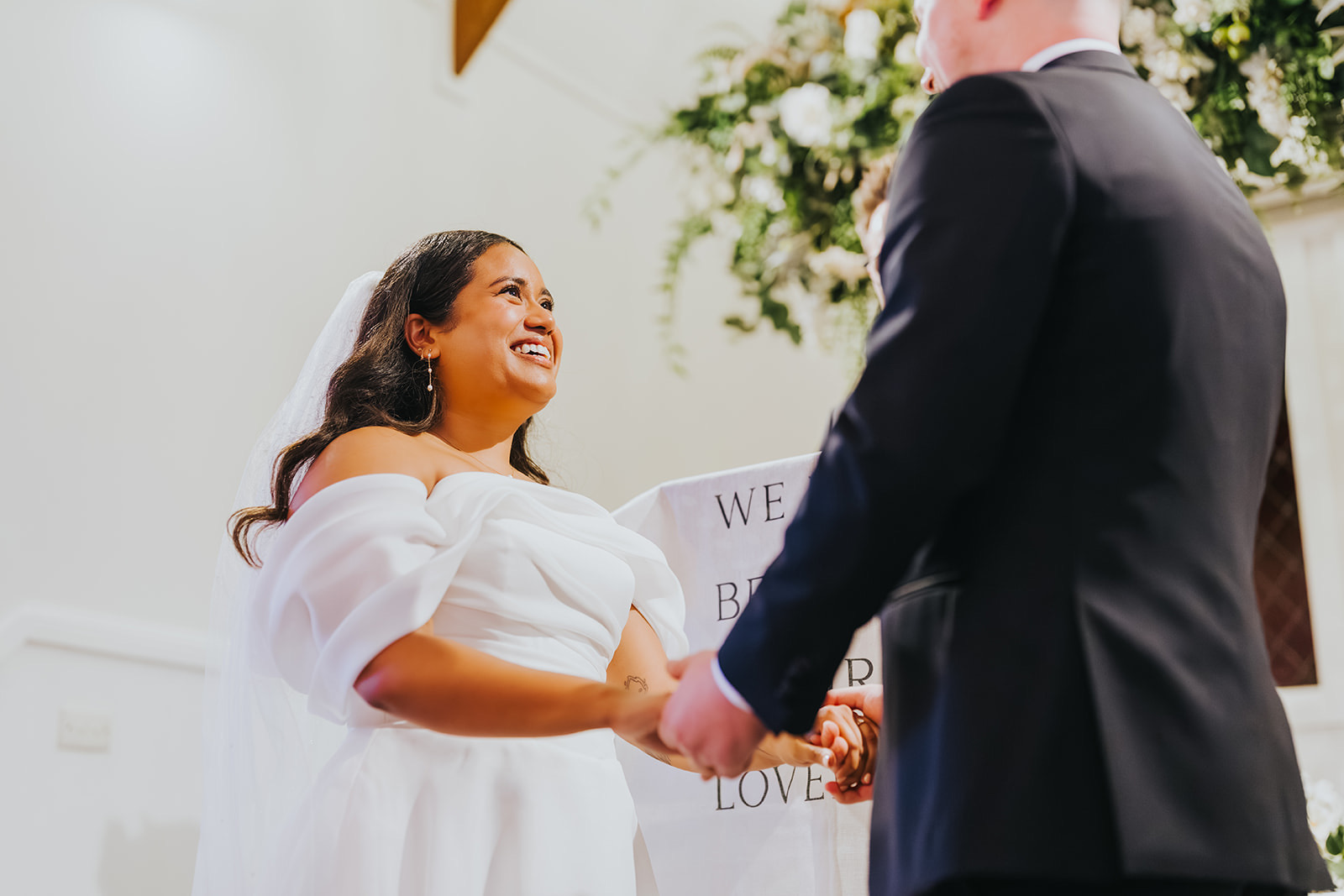 Sophia and Lachlan holding hands during their vows in the La Pera Estate chapel