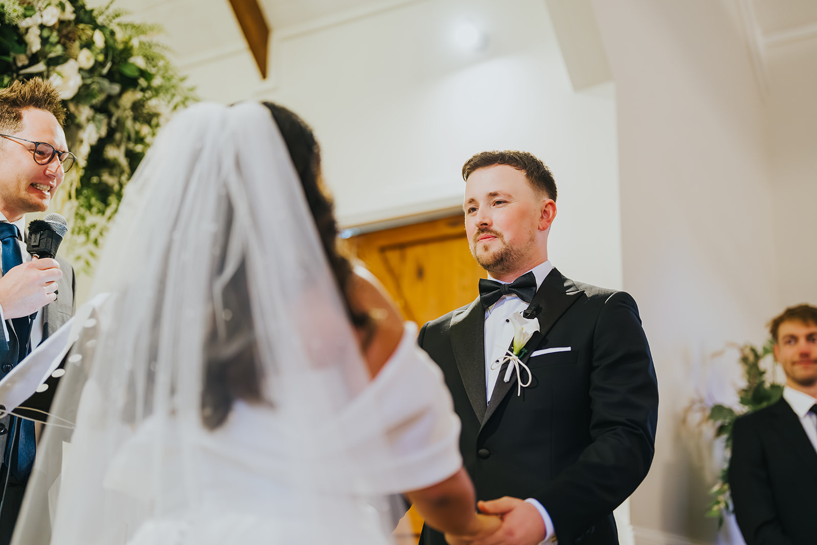 Lachlan smiling at Sophia beneath her veil at the altar