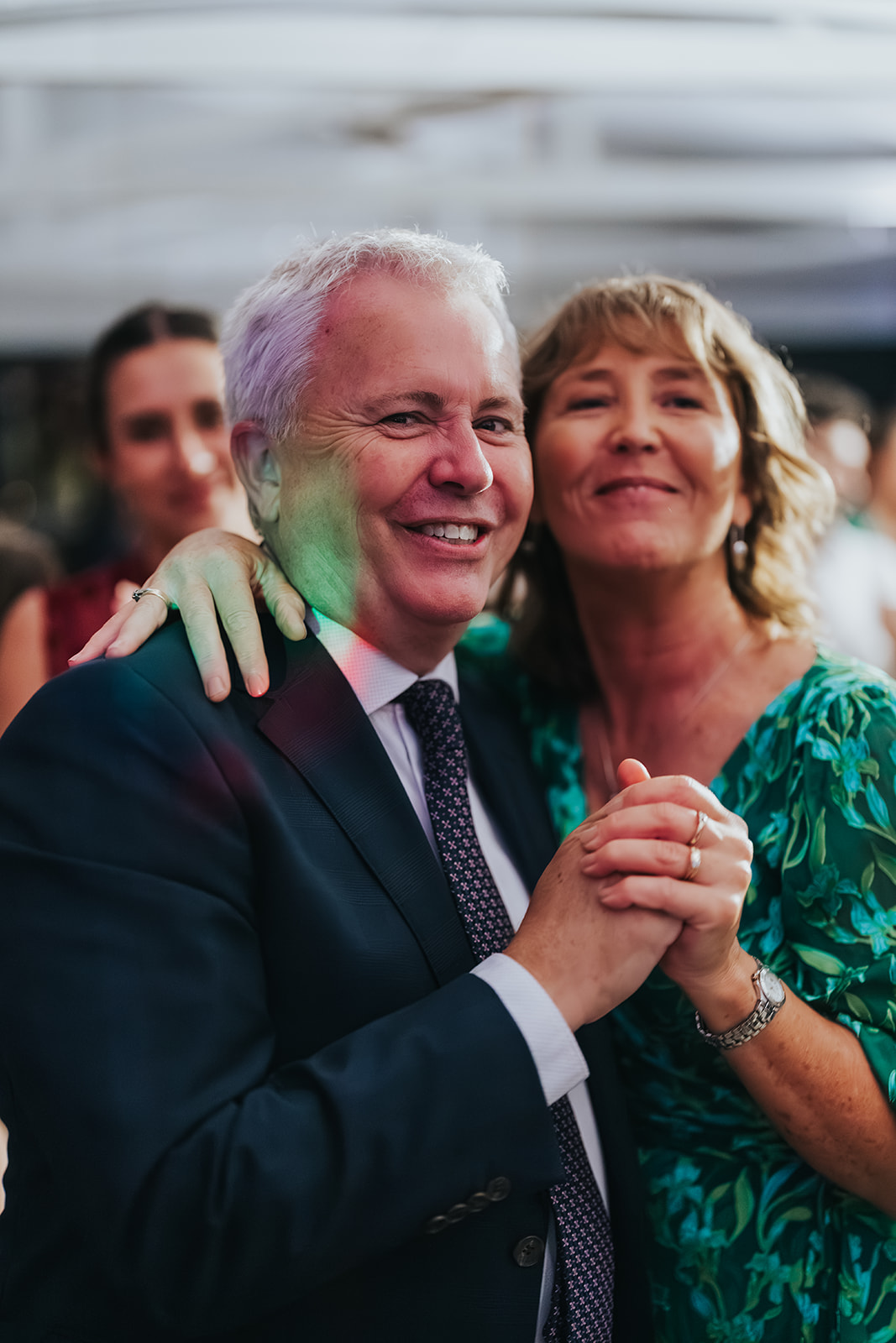 Guests dancing as a couple under the lights