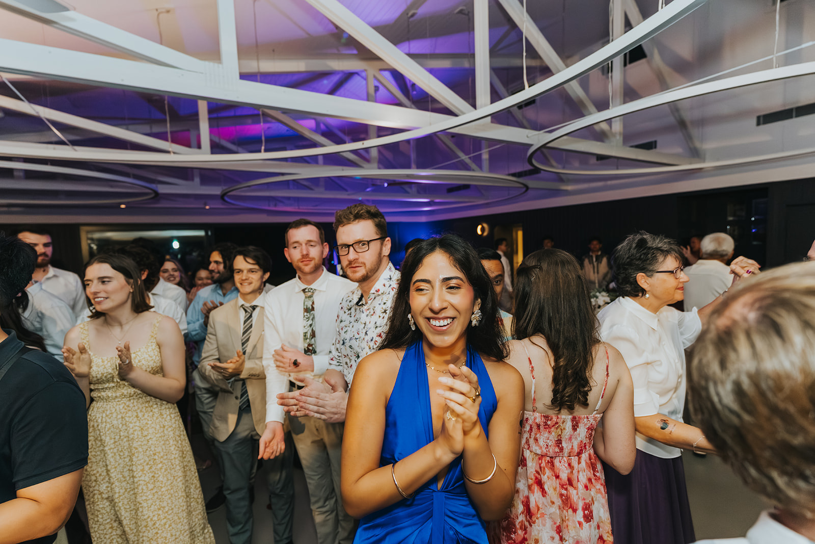 Guests dancing around the newlyweds