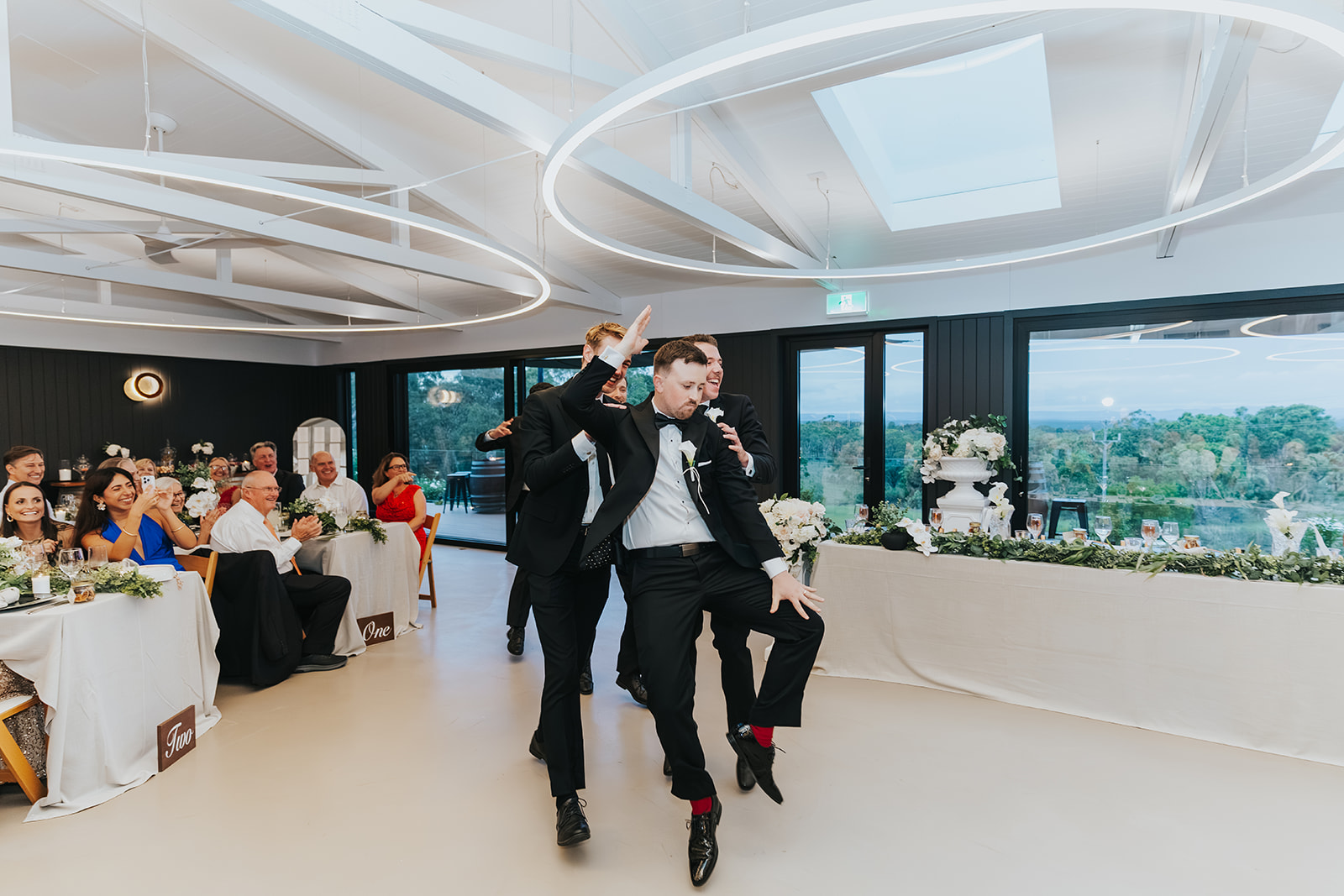 Groomsmen showing off their moves on the way in