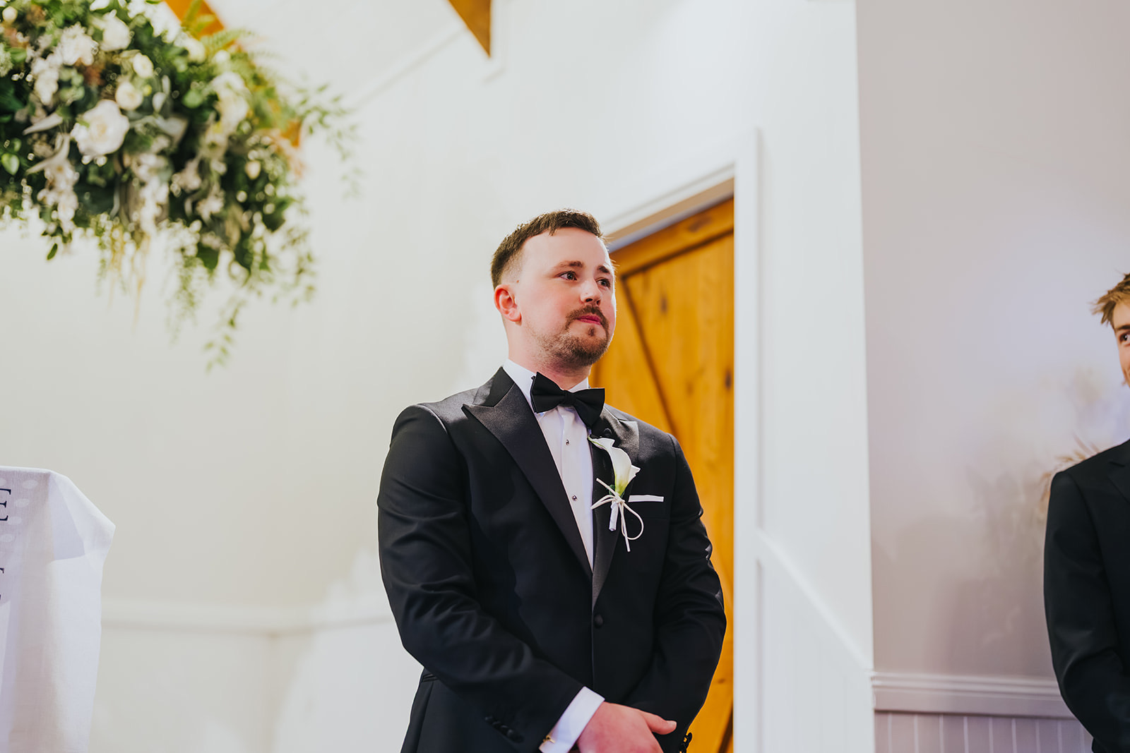 Lachlan waiting at the front of the chapel as Sophia arrives