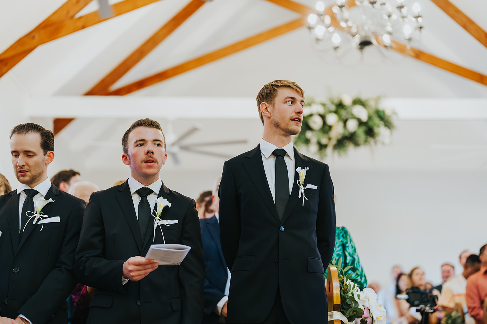 Groomsmen singing during the ceremony