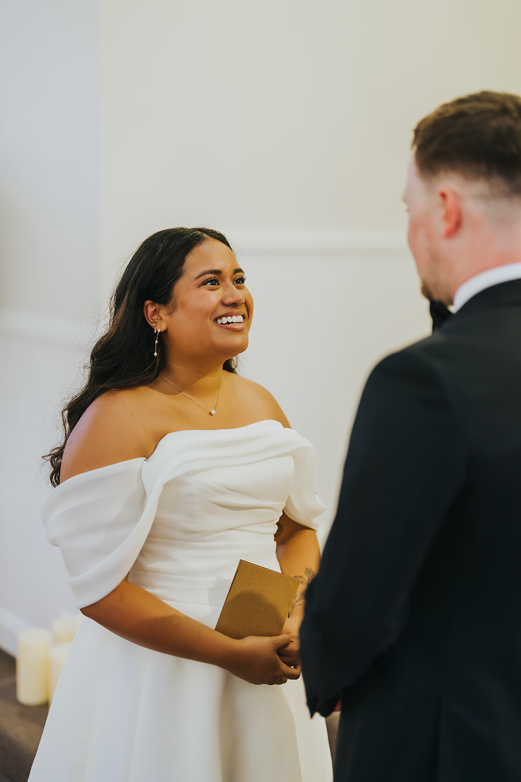 Sophia smiling as Lachlan reads his vows