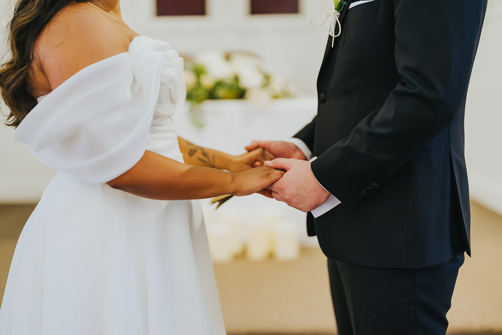 Lachlan holding Sophia's hands during their private vows