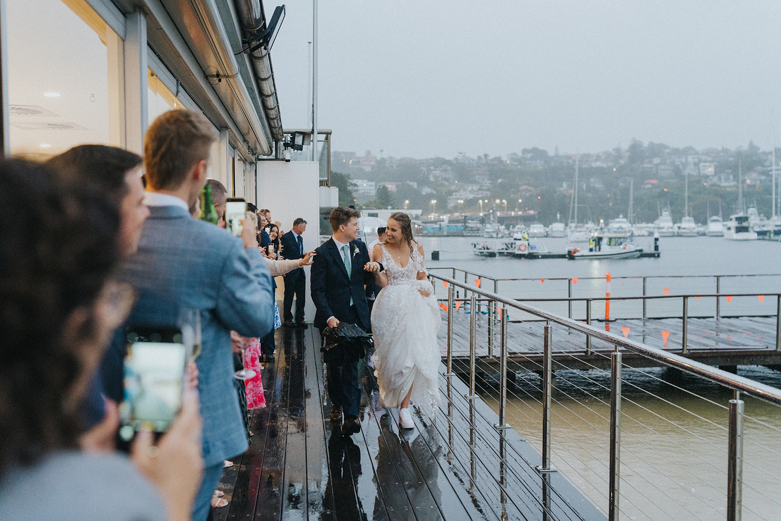 Wedding guests on the Orso Bayside balcony overlooking Middle Harbour