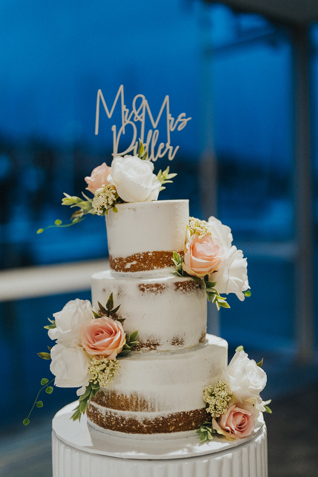 Wedding cake at Orso Bayside with Middle Harbour behind it