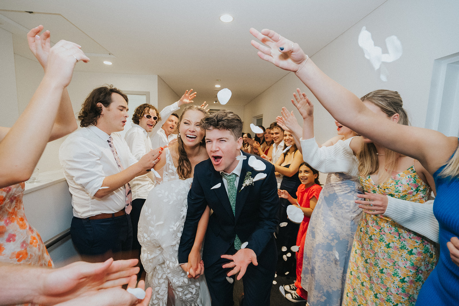 Guests cheering Ben and Naomi on their way out