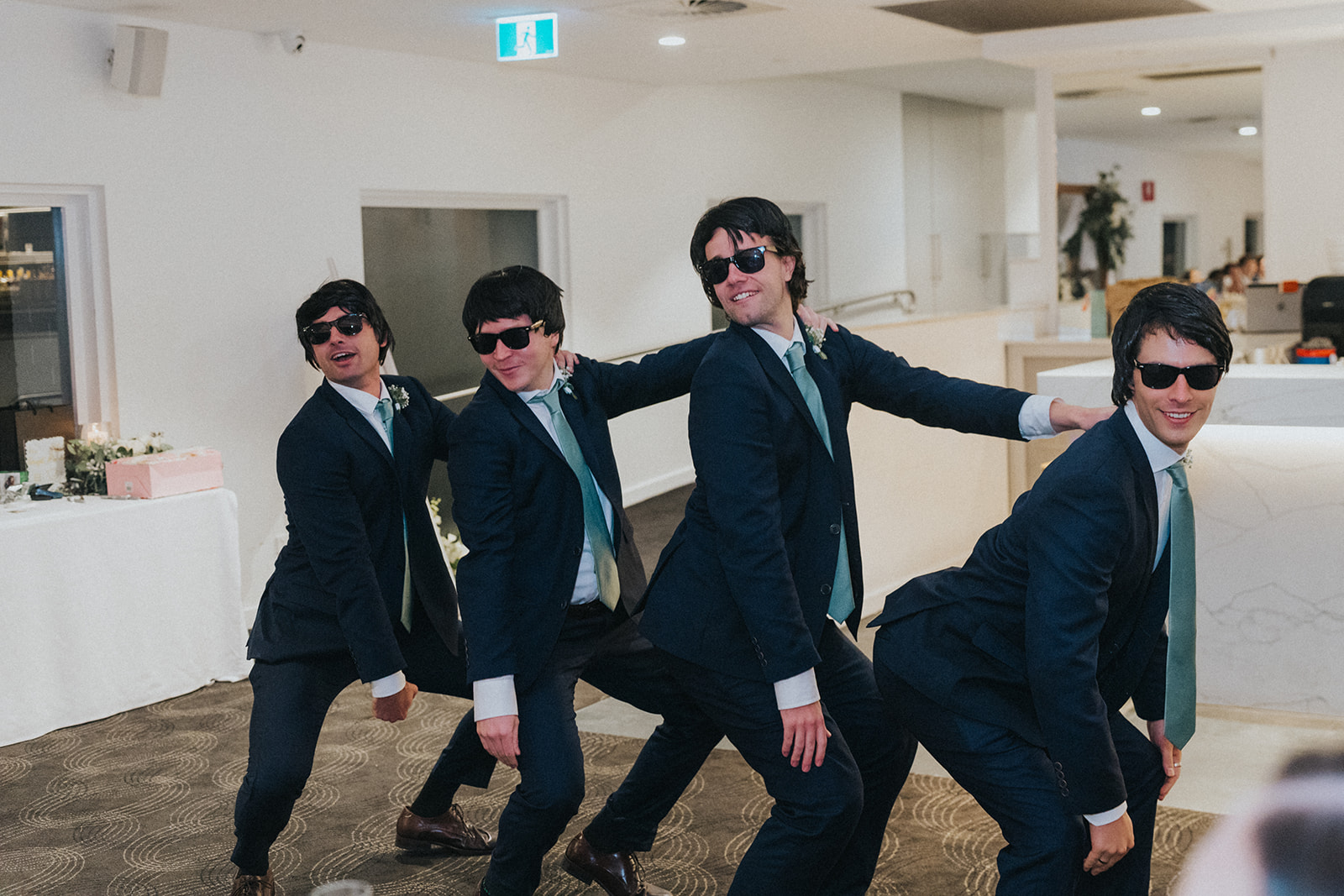 Groomsmen in sunglasses dancing into the Orso Bayside reception