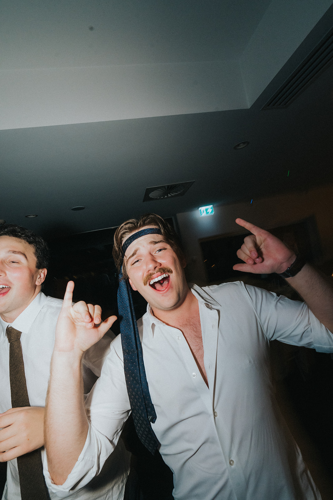 A guest laughing mid-dance late in the night