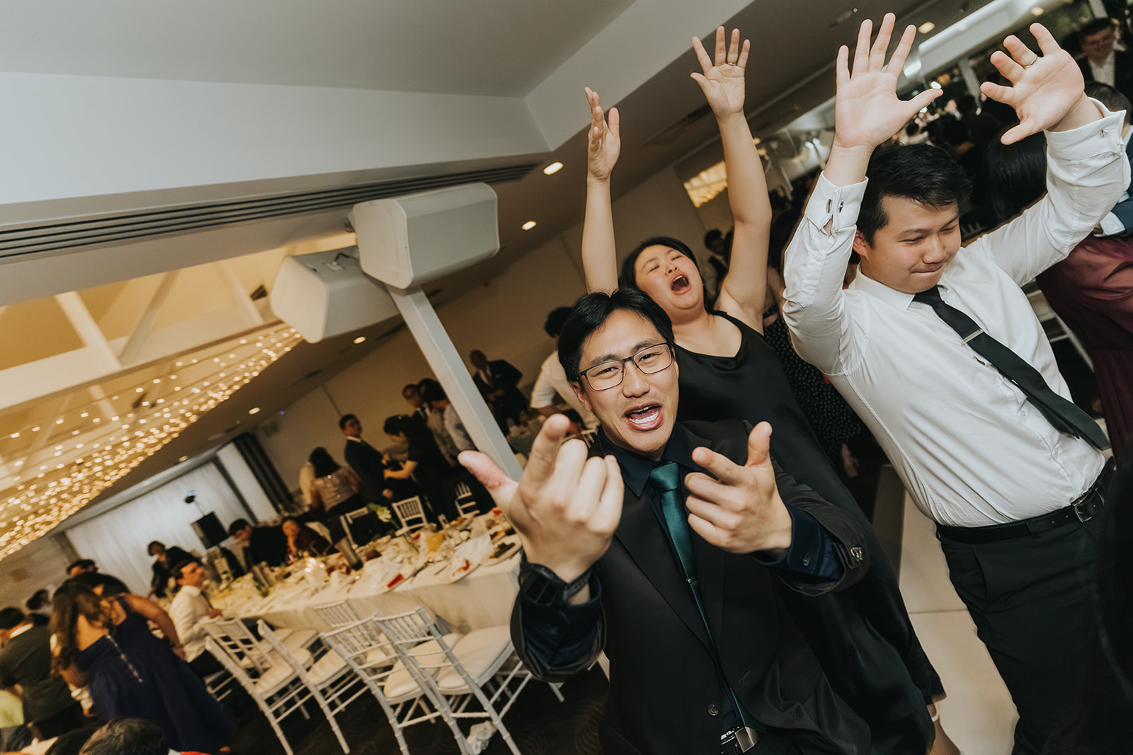 Guests with hands in the air on the Orso Bayside dance floor