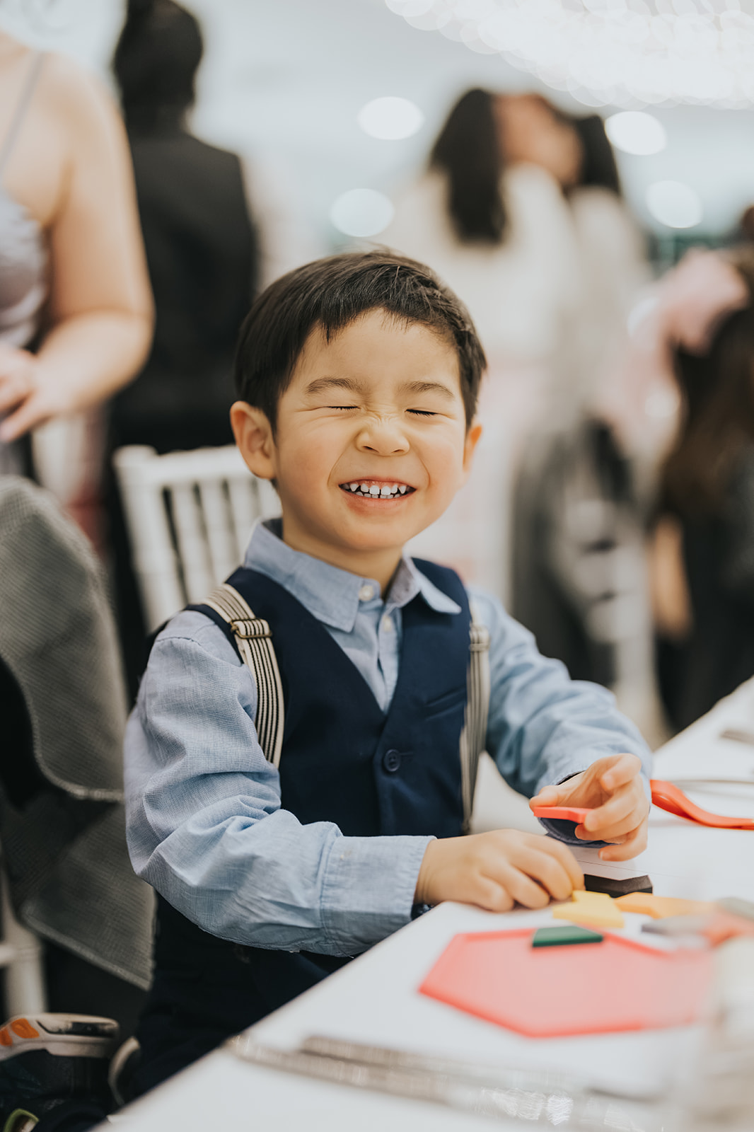 A young page boy grinning at the reception