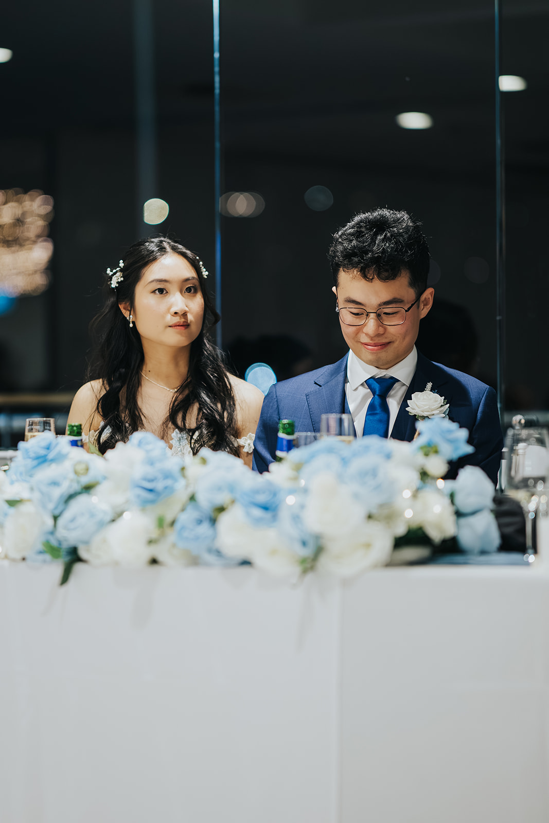 The newlyweds at their flower-covered bridal table