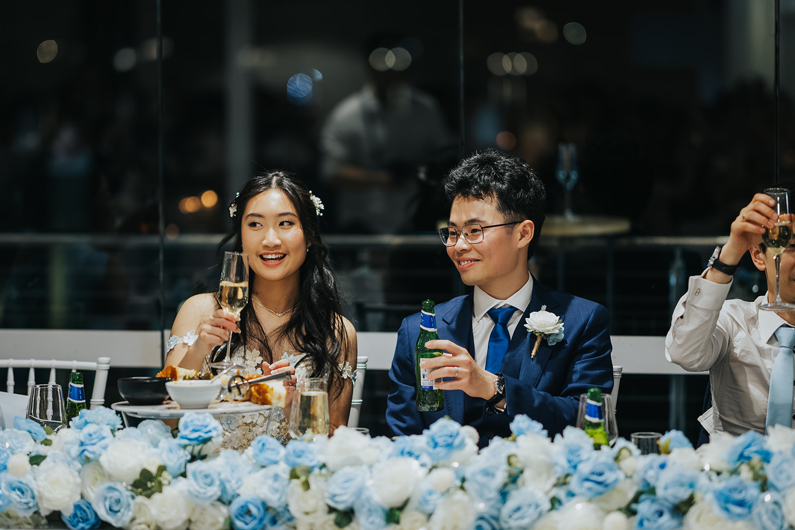 Rabi and Shaphir laughing at the bridal table during speeches