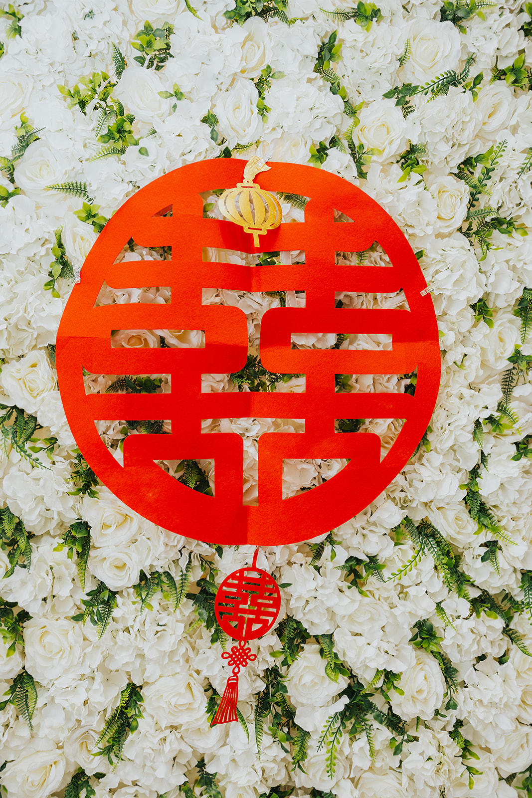 Red double happiness sign on the white flower wall
