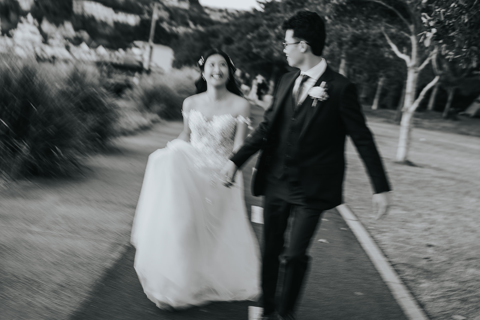 Couple walking along the waterfront path at The Spit near Orso Bayside