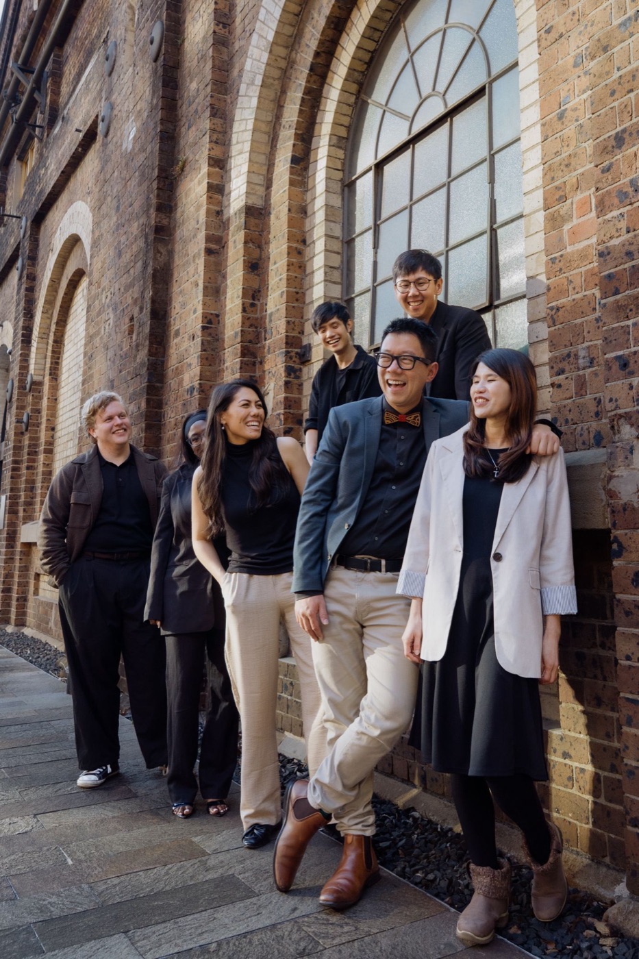 Frankie and the Salt Shaker Films team laughing together outside a heritage brick building